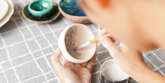 close-up-woman-making-ceramic-pottery-tableware-workshop-working-with-clay-1