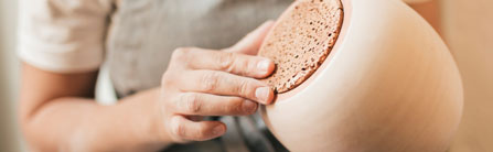midsection-skilled-potter-holding-ceramic-pot-hand-1