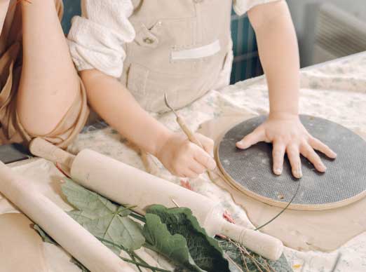 portrait-mother-little-girl-shaping-clay-together-1